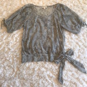 Black and cream blouse w/ ties on arms & waist